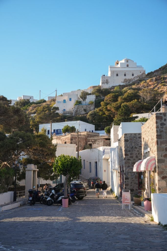 Whitewashed hillside buildings along a cobblestone street in Plaka