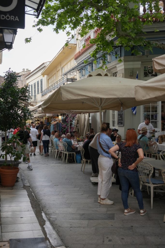 Crowded pedestrian street with outdoor dining in Plaka