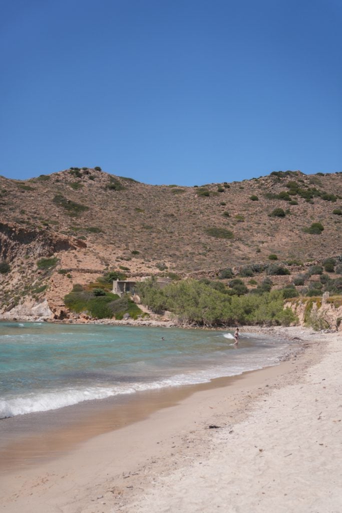 Plathiena Beach beneath rocky hills in Milos