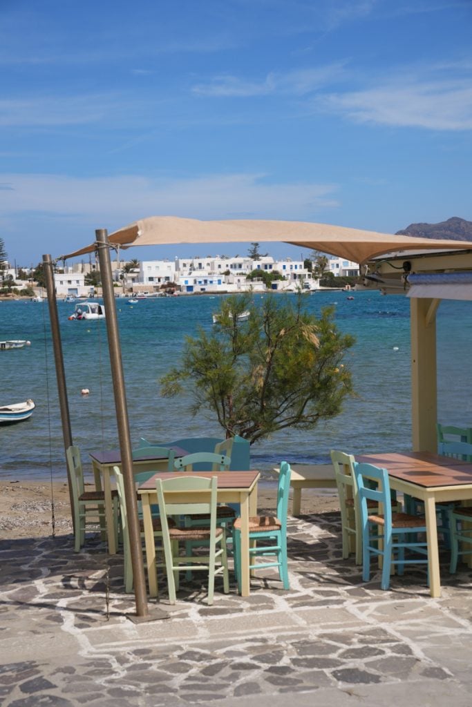 Pastel café tables overlooking Pollonia harbor