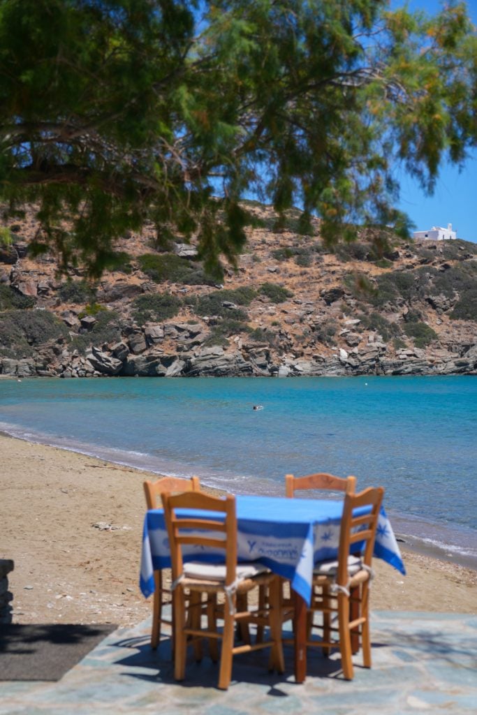 Beachside table overlooking turquoise water at Chrisopigi-Lembesis