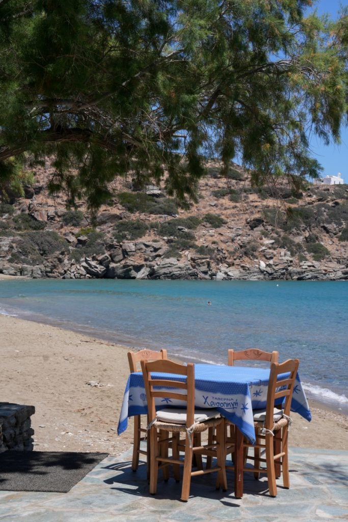 Beachfront dining table overlooking a turquoise cove