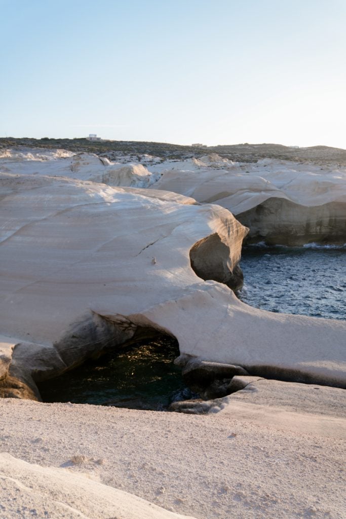 Sea caves carved into Sarakiniko’s white volcanic rock