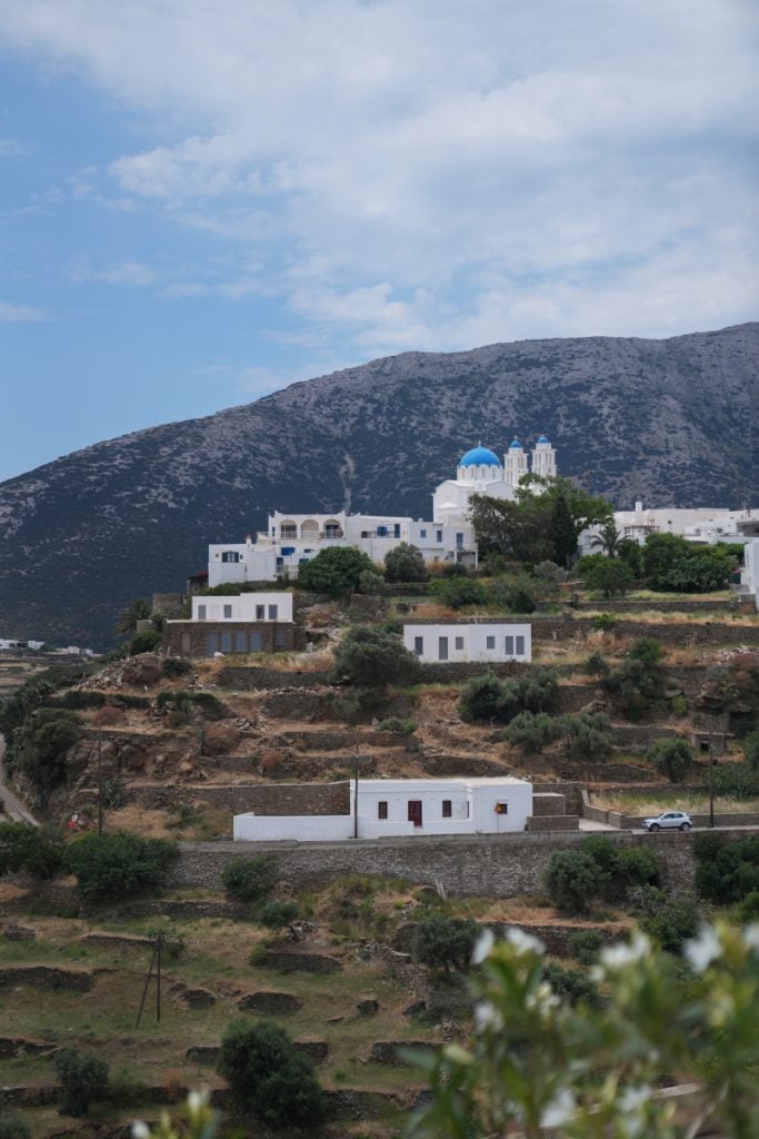 Blue-domed church among hillside homes in Sifnos
