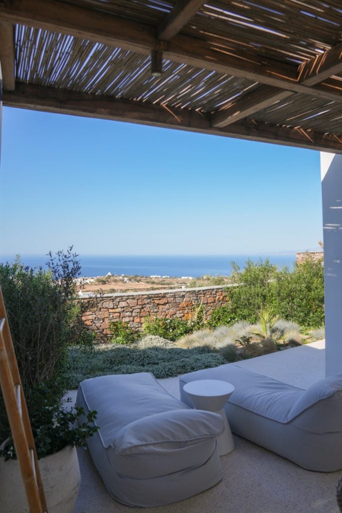 Shaded outdoor seating with a sea view at Stamna Hotel.