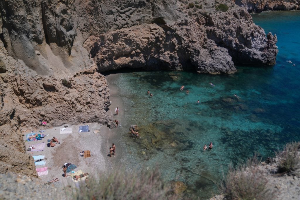 Swimmers in the rocky cove at Tsigrado Beach