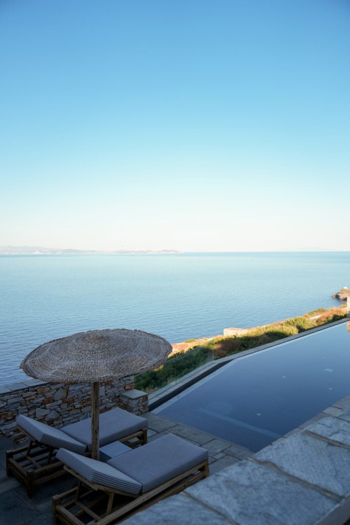 Infinity pool and shaded loungers overlooking the sea at Verina Astra.