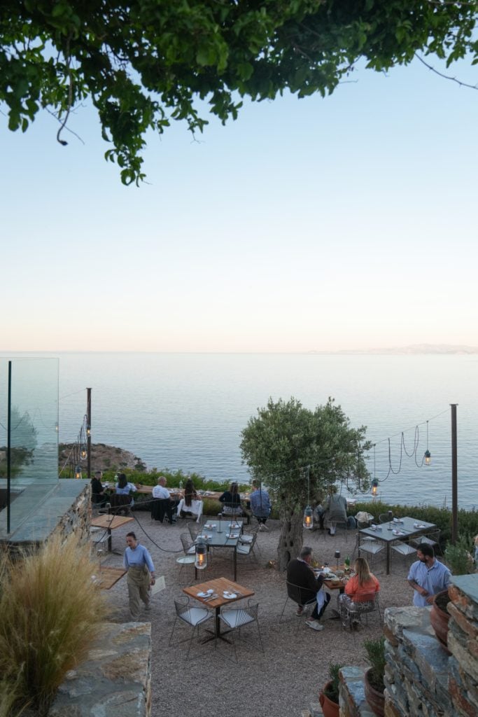 Outdoor tables overlooking the sea at Bostani Bar, Verina Astra.