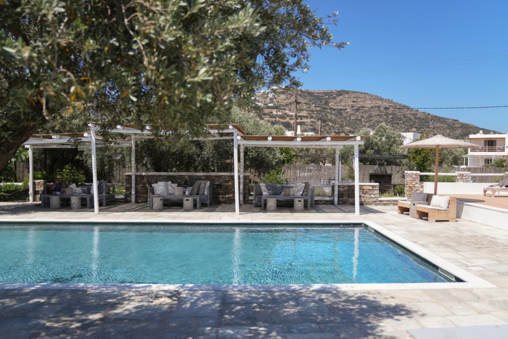 Swimming pool and shaded outdoor seating at Verina Terra in Platis Gialos.