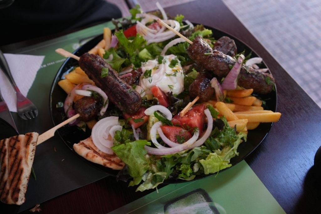 Souvlaki platter with fries and Greek salad at Victory