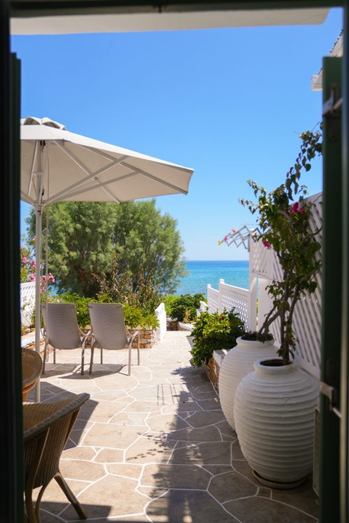 Patio at Villa Glaros opening toward the beach and sea at Platis Gialos.