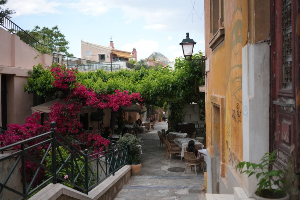 Bougainvillea-covered restaurant lane in Plaka