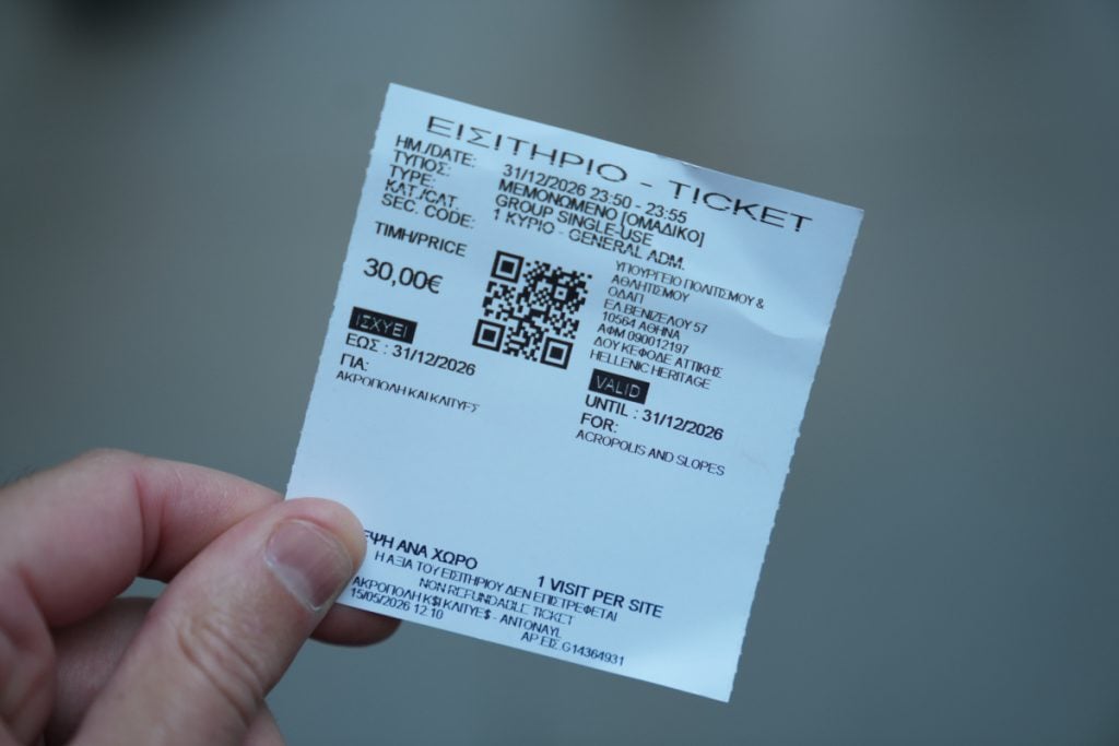 Hand holding a timed-entry ticket for the Acropolis