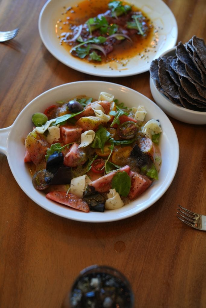 Colorful salad and tortilla chips at Aldea