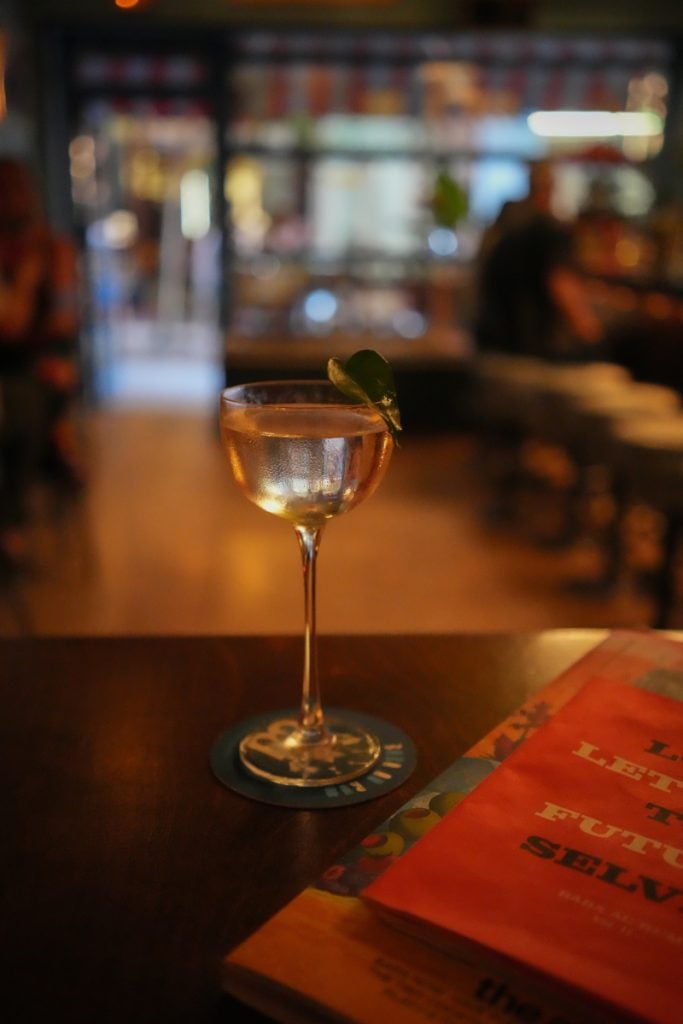 Cocktail with a leaf garnish at Baba au Rum