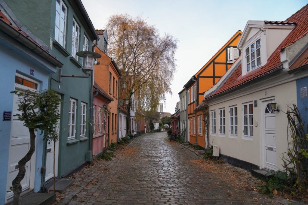 Colorful houses lining cobbled Møllestien Street in Aarhus