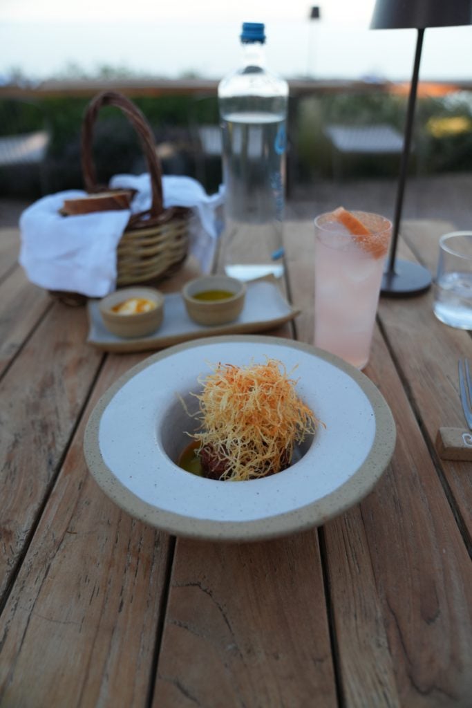 Plated dish and pink drink at Bostani Bar