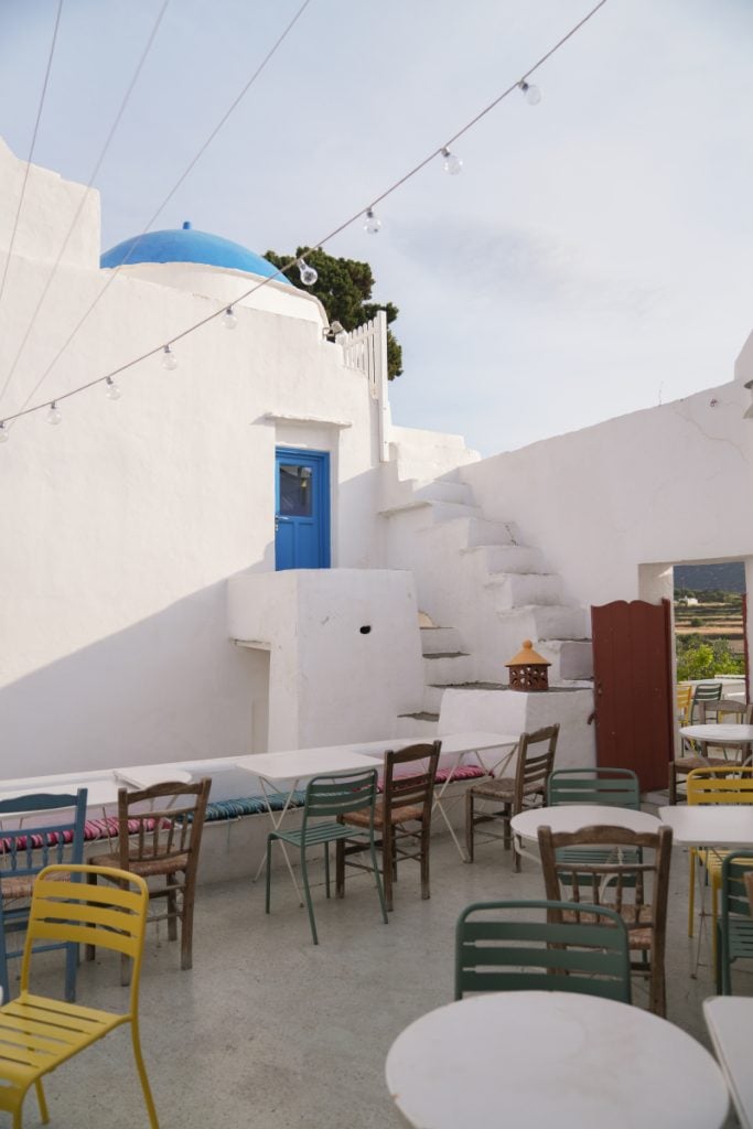Cafe Mosaic courtyard with colorful chairs and whitewashed walls
