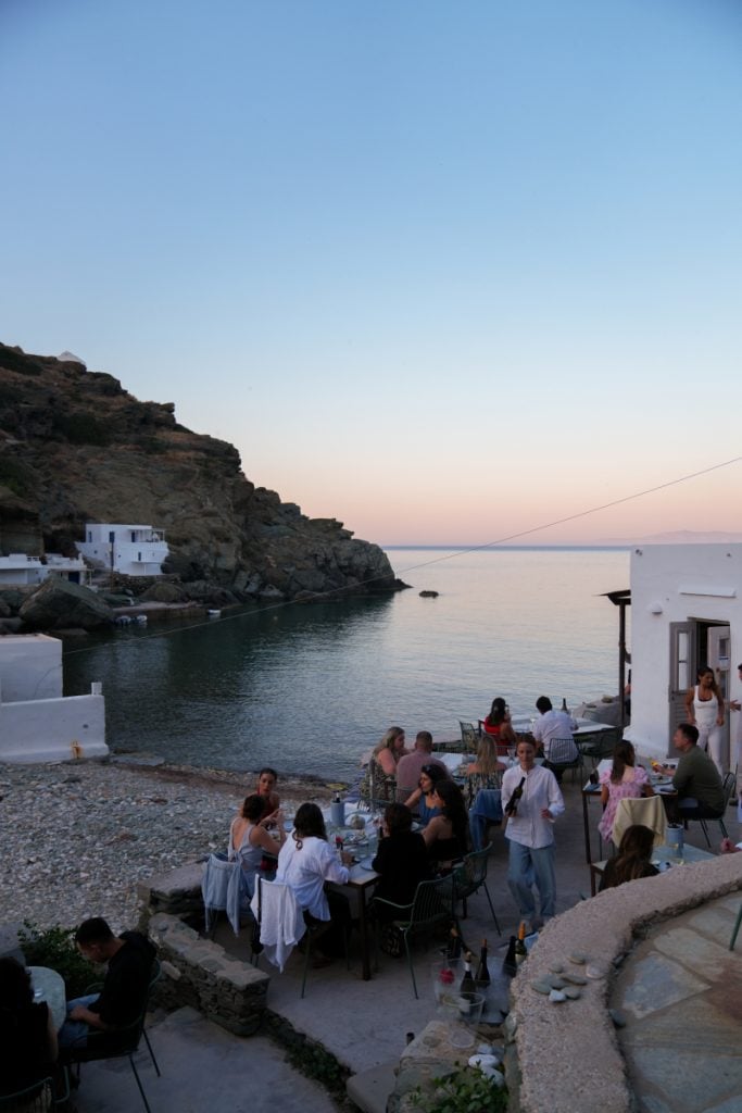 Diners beside the cove at Cantina in Sifnos