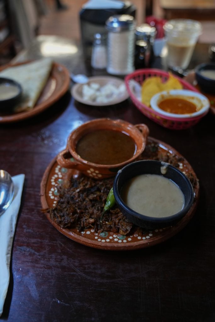 Shredded meat with side bowls at La Cocina de Doña Esthela