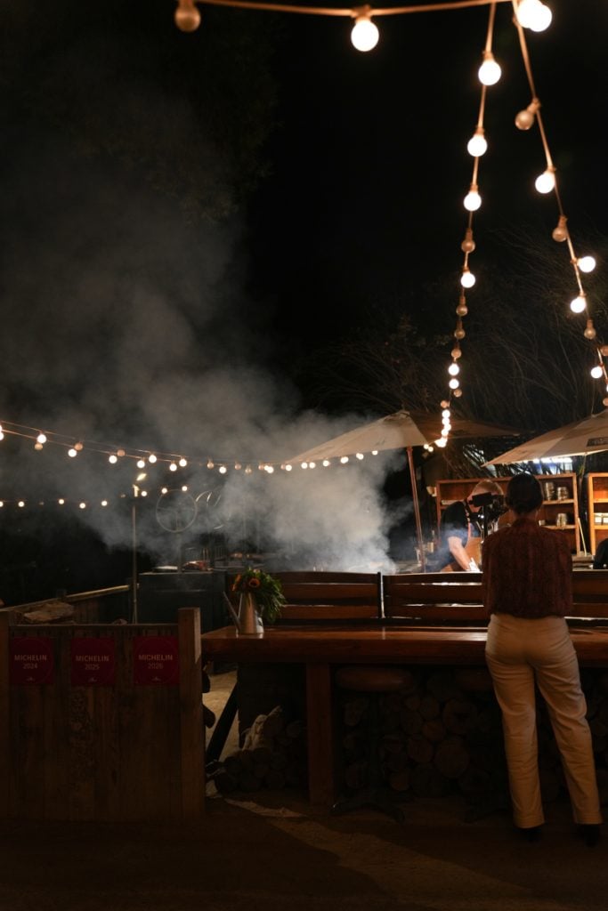 Smoky outdoor kitchen at Deckman's under string lights
