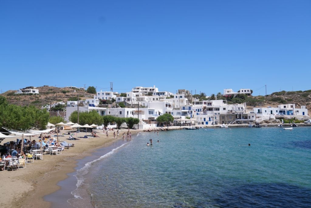 Faros Beach lined with restaurants and whitewashed buildings