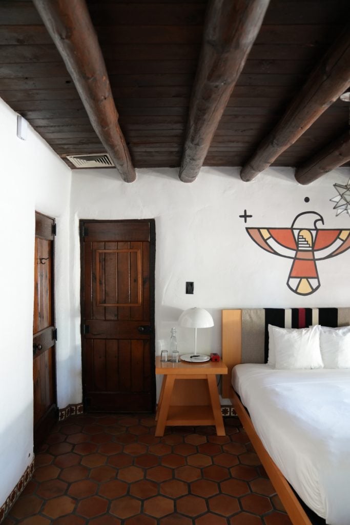 El Rey Court guest room with a painted bird mural