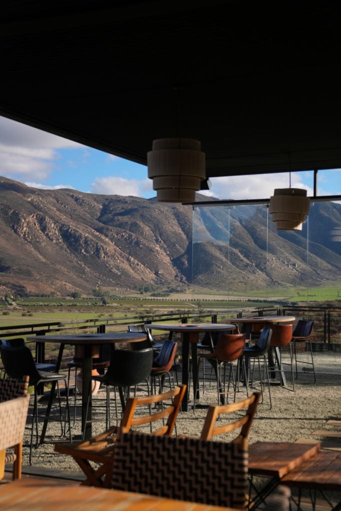 Encuentro Guadalupe patio overlooking rugged valley mountains