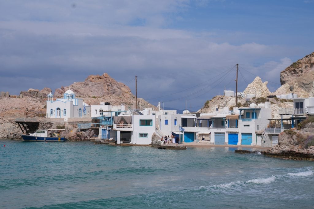 Whitewashed waterfront homes and church in Firopotamos