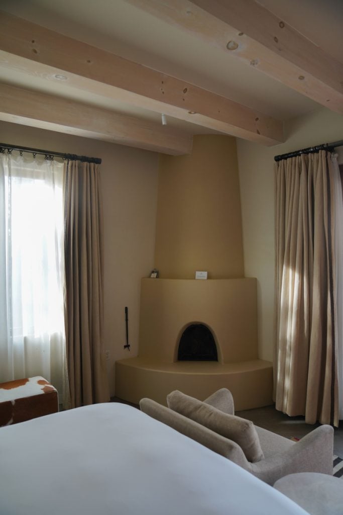 Guest room with adobe fireplace and exposed wood beams