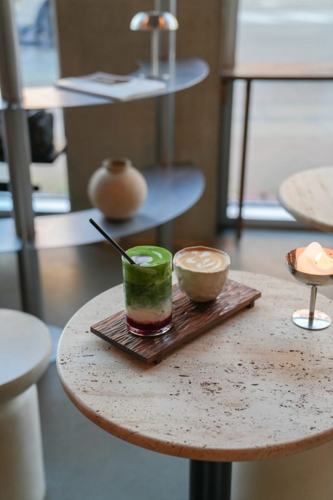 Layered matcha and latte on a tray at Hakkō