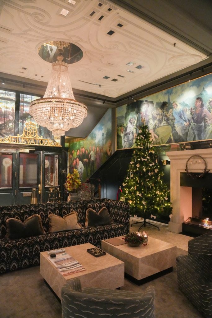Hotel Royal lobby with chandelier, Christmas tree, and fireplace