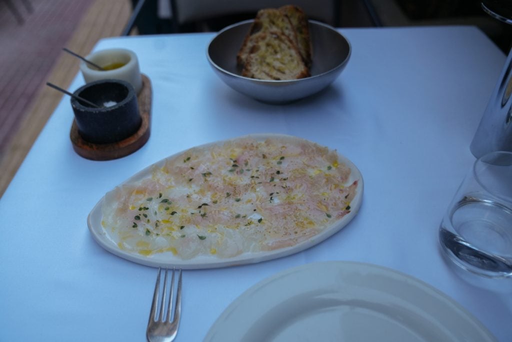 Fish crudo with herbs and olive oil at Iodio