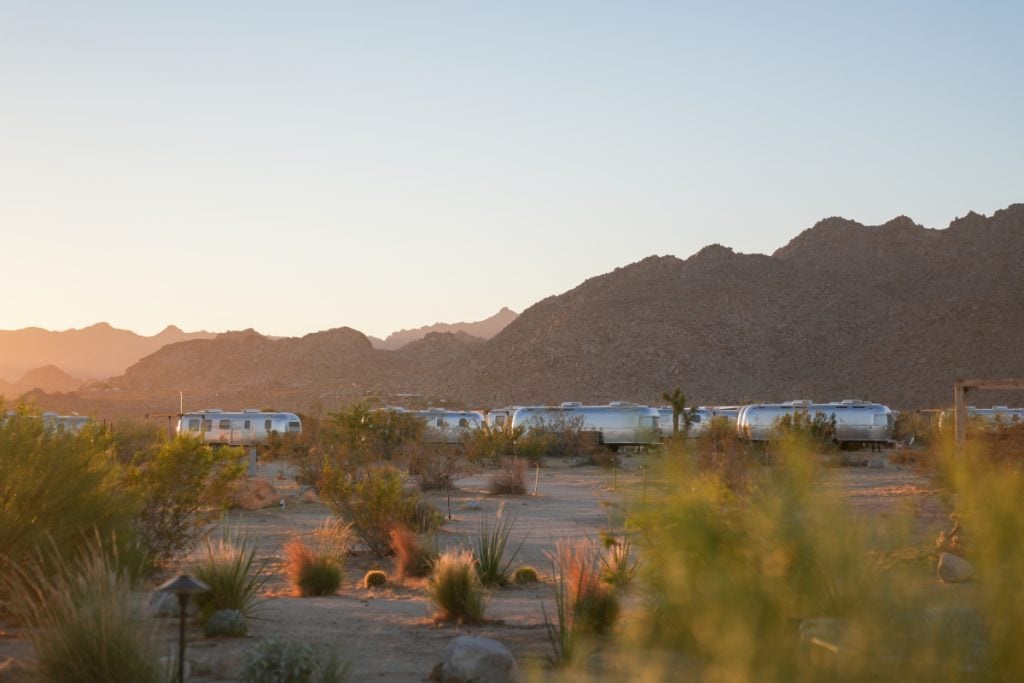 Airstream trailers beneath rocky mountains at AutoCamp Joshua Tree