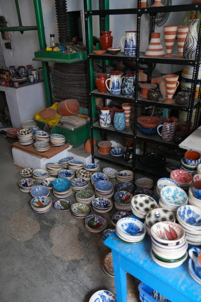 Shelves and stacks of ceramics at Lembesis Pottery
