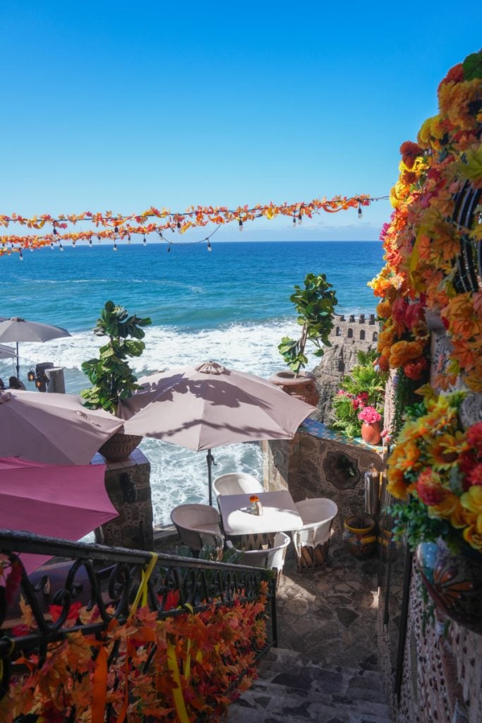 Flower-covered oceanfront terrace at Los Portales de García