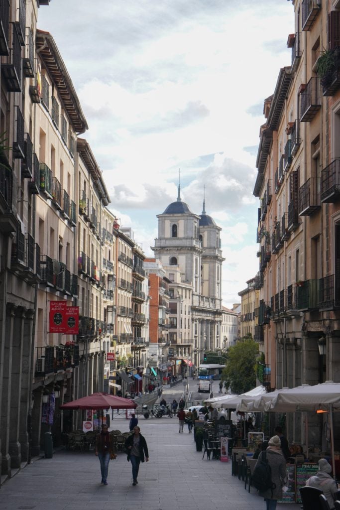 Pedestrians and café terraces on a street in central Madrid