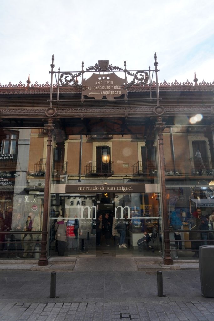 Glass entrance and ornate ironwork at Mercado de San Miguel