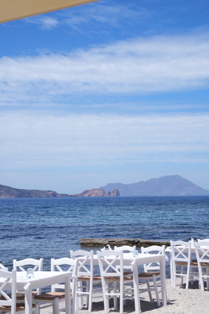 White taverna tables overlooking the sea in Milos
