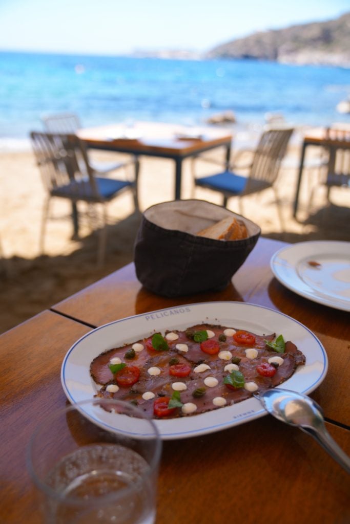 Plated appetizer at Pelicanos with the beach beyond