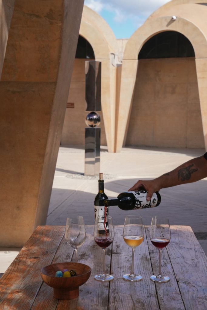 Wine poured into a glass at Pictograma Vinícola
