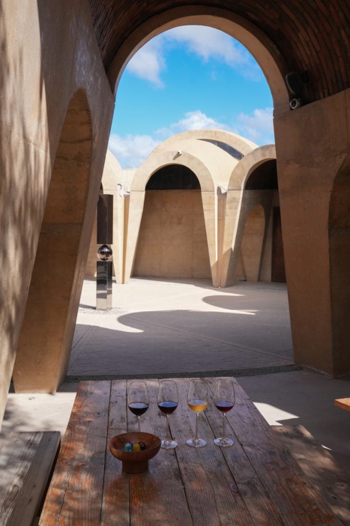 Wine tasting beneath curved arches at Pictograma Winery
