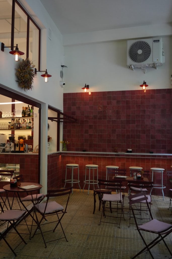 Red-tiled wine bar interior in Koukaki