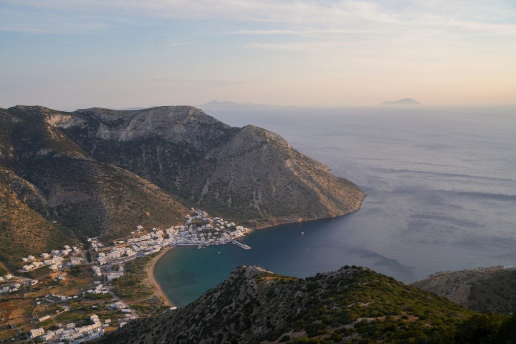Coastal village and bay viewed from Agios Symeon at sunset
