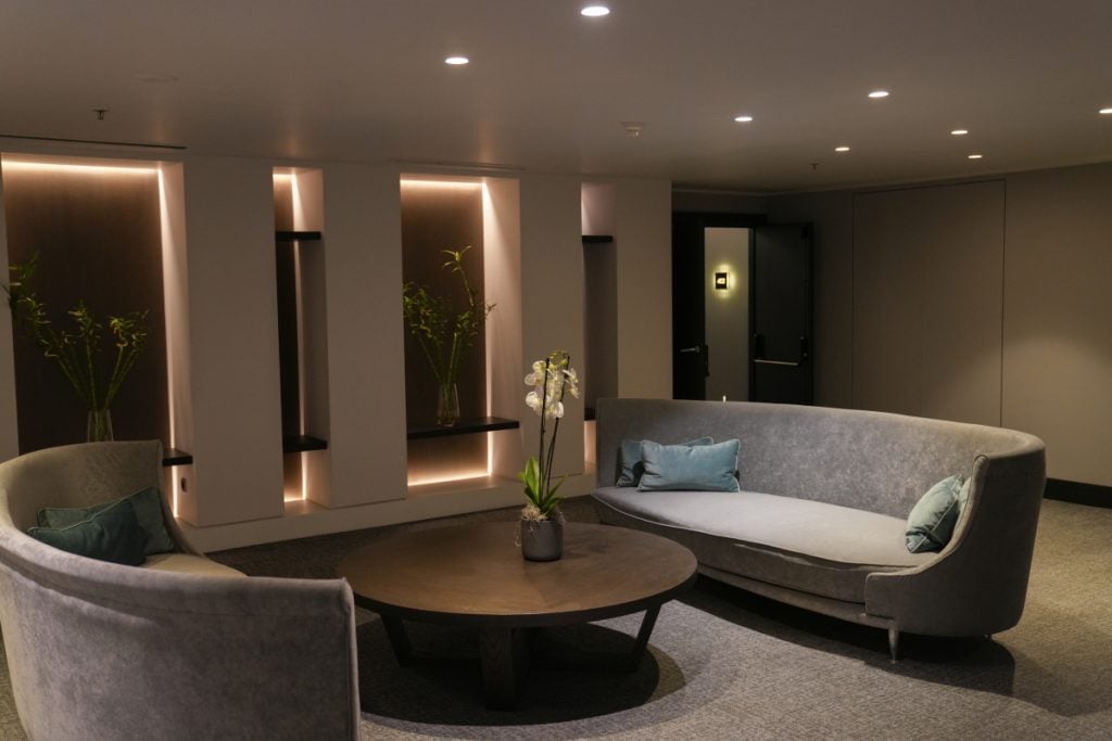 Sofitel Athens Airport lounge with curved gray sofas