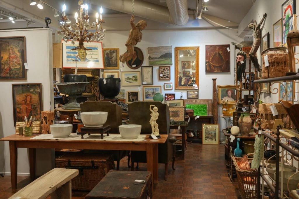Furniture, framed artwork and decorative objects inside Summerland Antique Collective