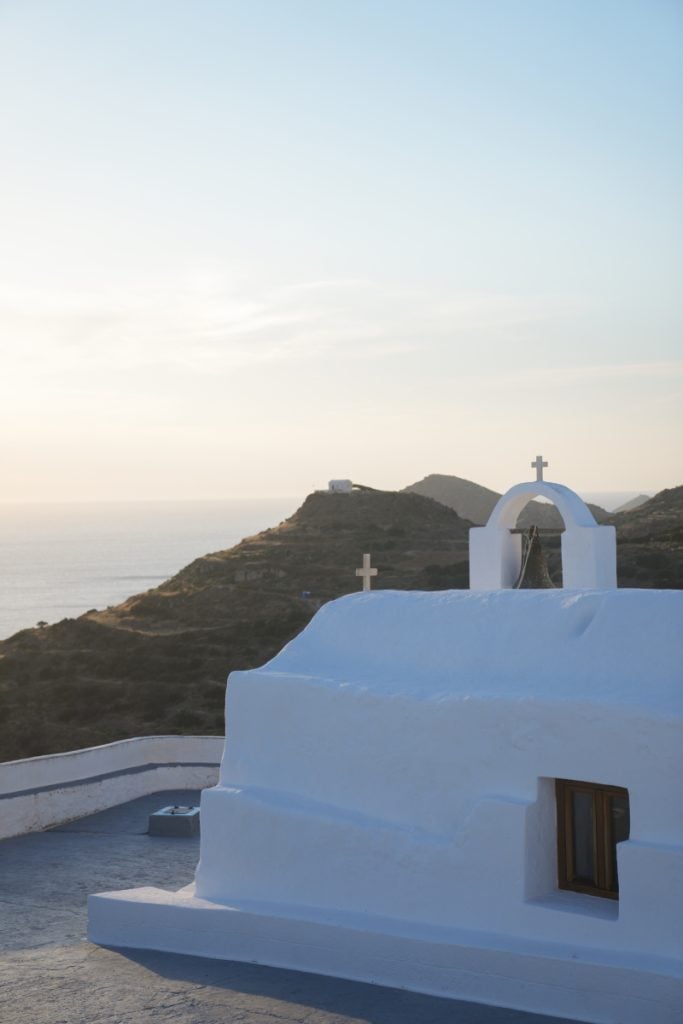 Panagia Tourliani Chapel overlooking the sea at sunset