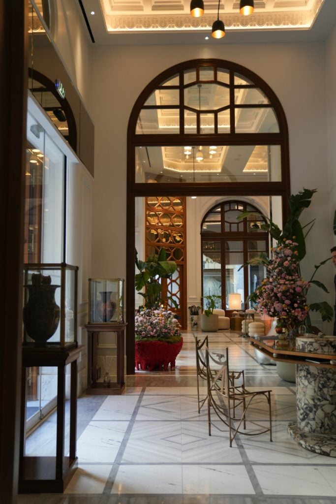 Marble lobby with floral arrangements at The Dolli