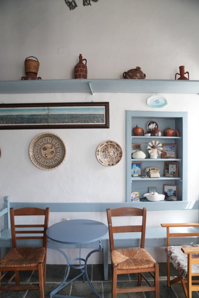 Ceramics and wooden chairs inside Theodorou's sweet shop