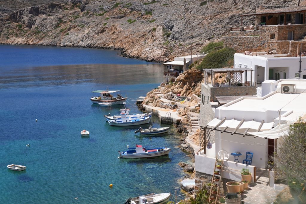 Fishing boats moored along the rocky Cheronissos shoreline